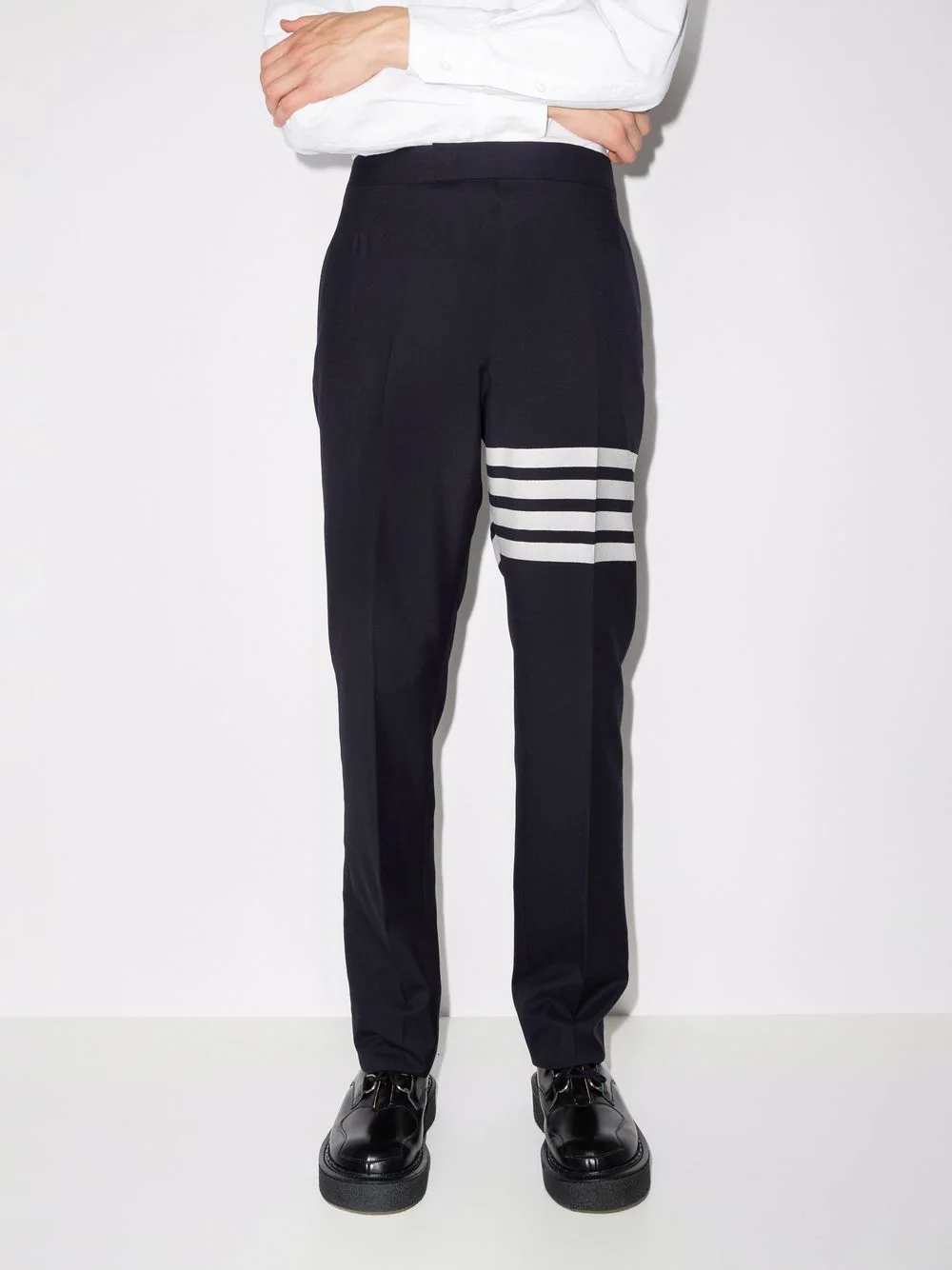 Thom Browne Classic Backstrap Trouser in black with four-bar white stripe detail on the thigh, slim straight-leg silhouette