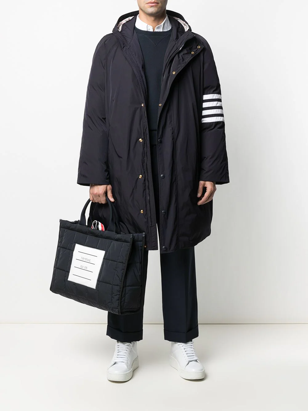 Thom Browne 4-Bar Football Sideline Parka in navy with white four-bar stripe on sleeve, snap-button front, attached hood, and striped red and white interior lining