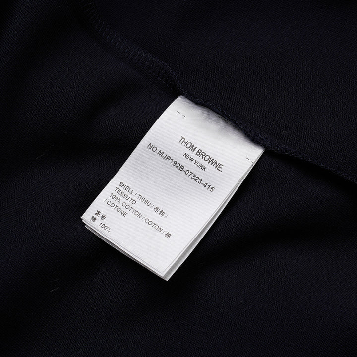 Thom Browne navy short sleeve polo with tonal 4-bar stripe on the sleeve, button placket, and woven brand label at the hem