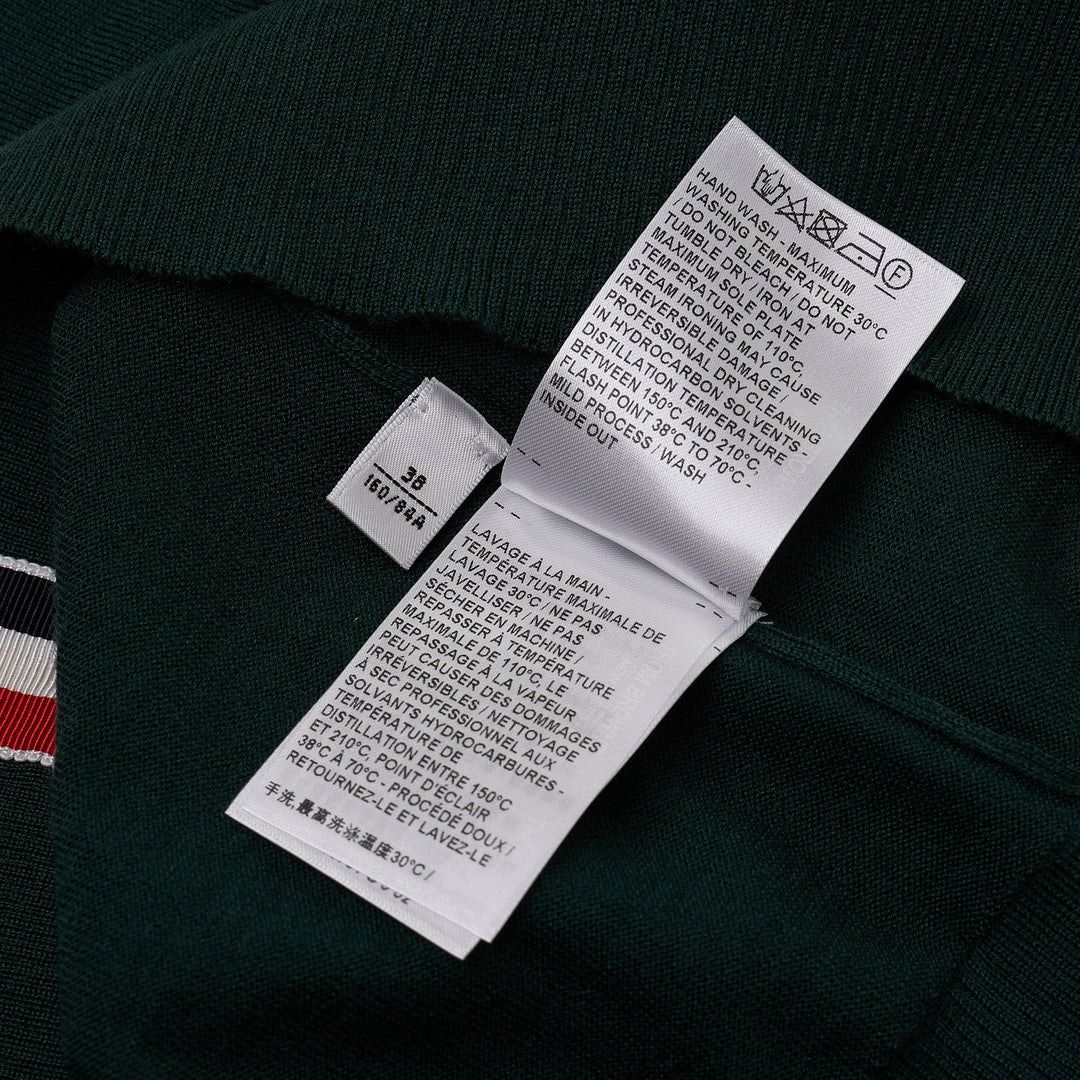 Thom Browne hunter green fine-knit polo with four-bar white stripe on sleeve, button placket, ribbed cuffs and hem