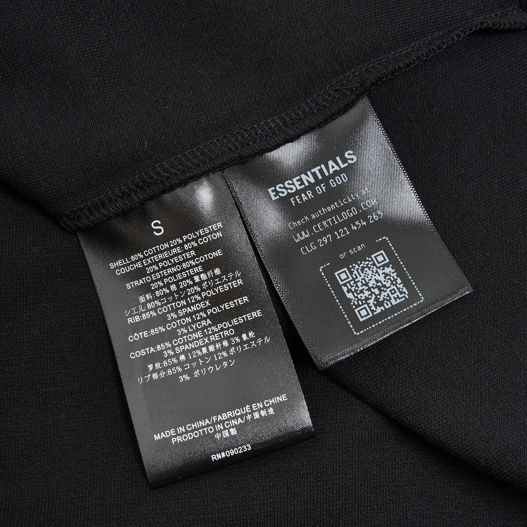 Fear of God ESSENTIALS Signature Cropped Polo Shirt in black with tonal logo embroidery and relaxed oversized fit