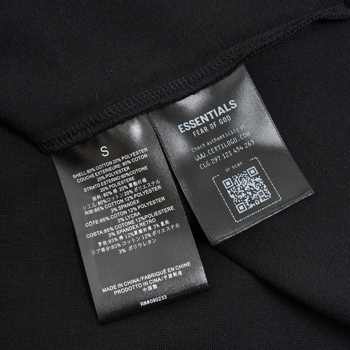 Fear of God ESSENTIALS Signature Cropped Polo Shirt in black with tonal logo embroidery and relaxed oversized fit
