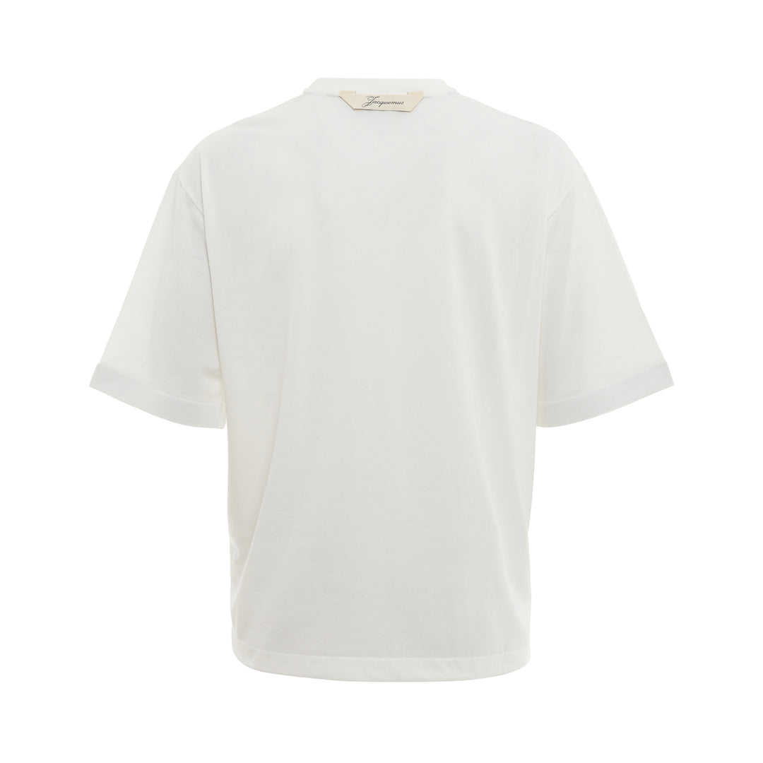 JACQUEMUS Round Square T-Shirt in white with a relaxed boxy fit and crew neckline, displayed on a flat ghost mannequin against a white background.