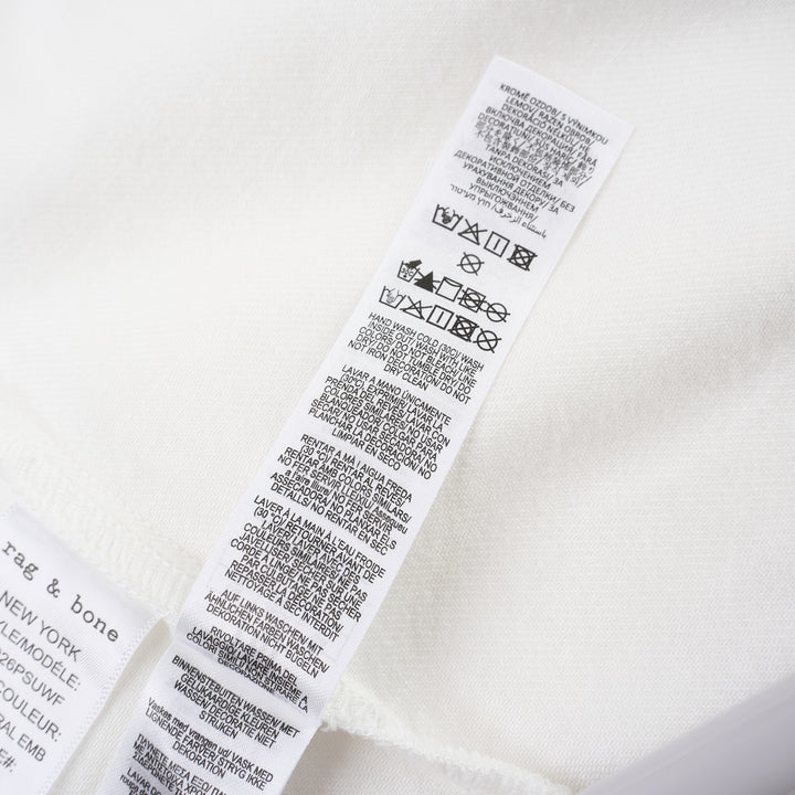 rag & bone Lucy Lace Popover Top in white with floral cutwork lace panels across the yoke and sleeve hems, open polo collar, and wide relaxed sleeves - view 4