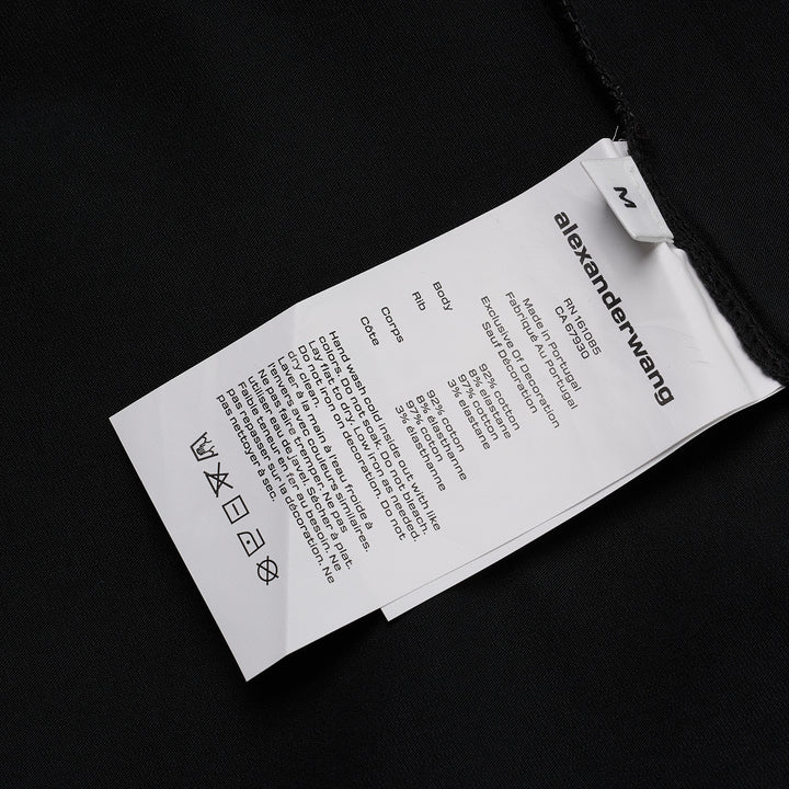 Alexander Wang white fitted crew-neck tee with hotfix crystal 'alexanderwang' logo text arranged in a radiating pinwheel sunburst pattern across the chest