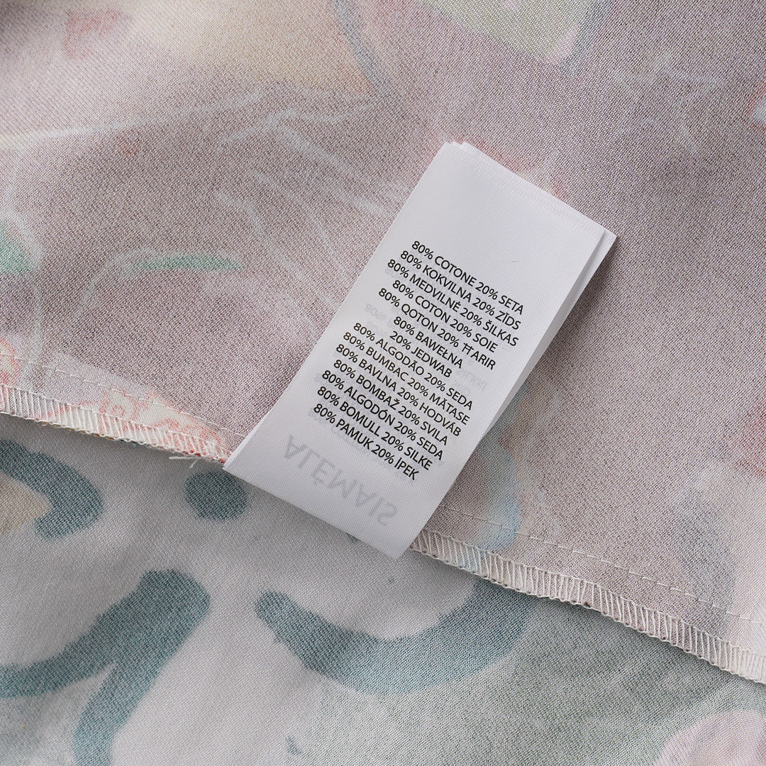Alemais Tangible Love short-sleeve shirt with patchwork hand-painted panels featuring crocodile, floral, and abstract motifs, oversized hem pockets, and contrast stripe trim on a white background