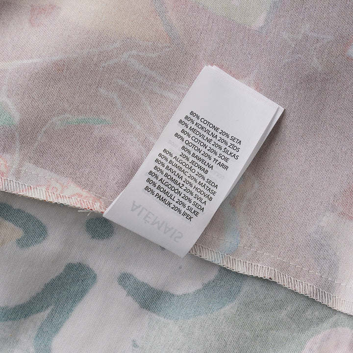 Alemais Tangible Love short-sleeve shirt with patchwork hand-painted panels featuring crocodile, floral, and abstract motifs, oversized hem pockets, and contrast stripe trim on a white background