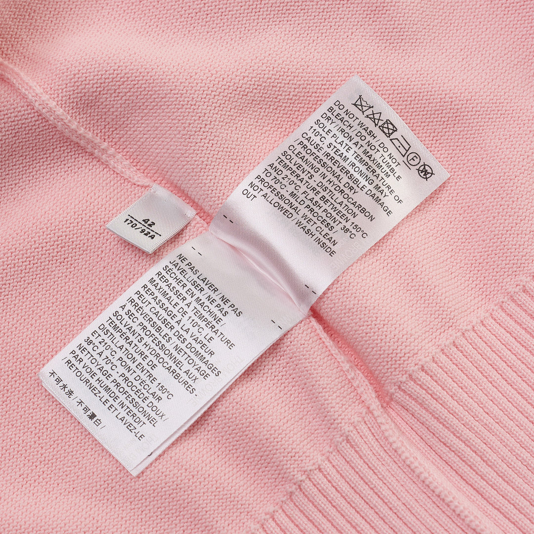 Thom Browne Short Sleeve Intarsia Knit Tee in baby pink with signature 4-bar cream stripe on the sleeve and contrast cream crew neckline, front view