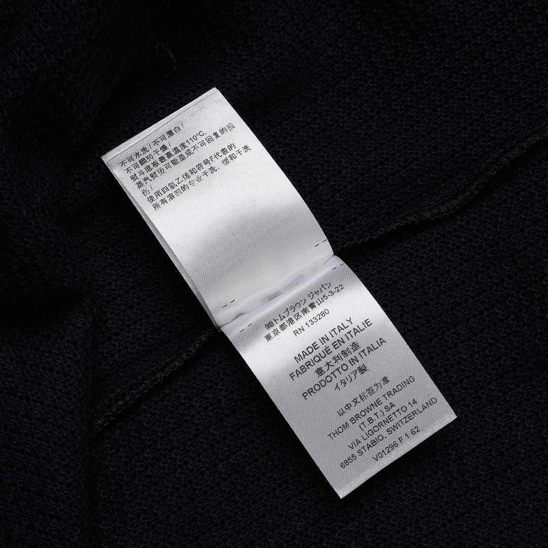 Thom Browne navy open-knit relaxed short sleeve tee with red, white, and blue striped ribbed crew neck collar and chest patch pocket