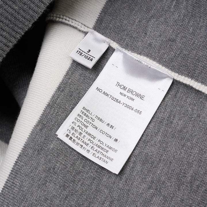 Thom Browne rugby stripe zip-up hoodie in heathered grey and white with signature four-bar stripe on sleeve, full-length zip, drawstring hood, and ribbed hem