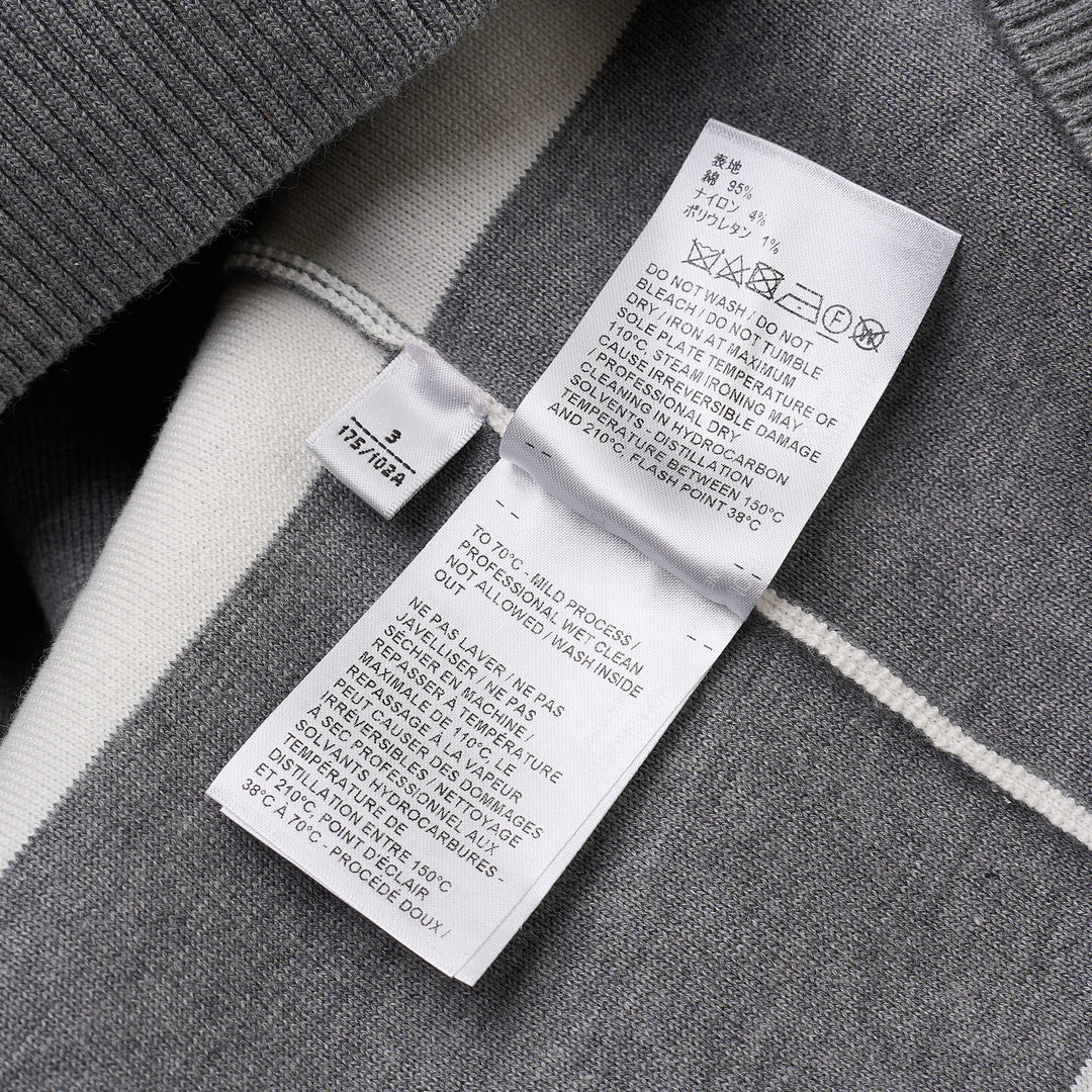 Thom Browne rugby stripe zip-up hoodie in heathered grey and white with signature four-bar stripe on sleeve, full-length zip, drawstring hood, and ribbed hem