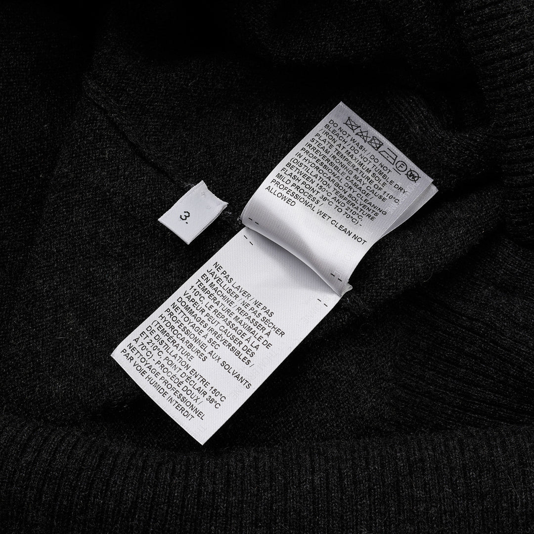Thom Browne Classic V-Neck Cardigan in dark charcoal grey with signature four-bar white and black stripe on the sleeve, button-front closure, and ribbed hem
