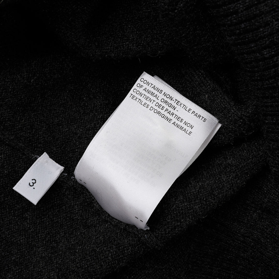 Thom Browne Classic V-Neck Cardigan in dark charcoal grey with signature four-bar white and black stripe on the sleeve, button-front closure, and ribbed hem