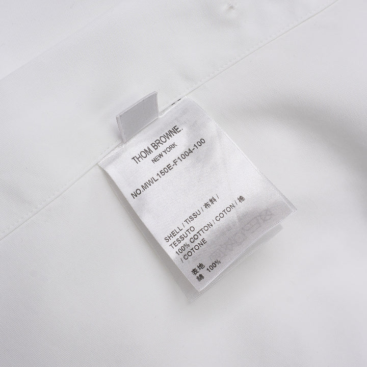 Thom Browne white long sleeve point collar shirt with signature red, white, and blue four-bar stripe on the sleeve, button-front placket, and chest pocket