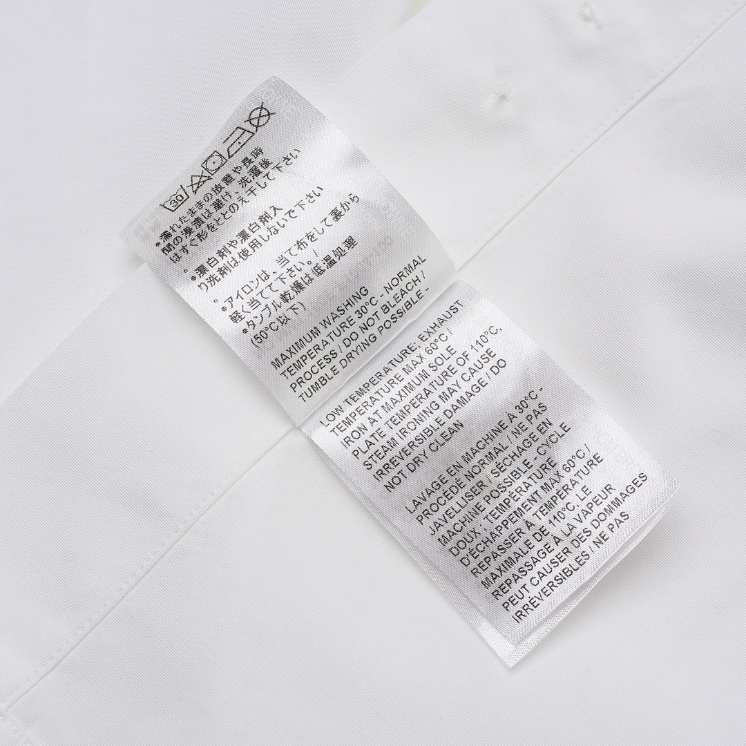 Thom Browne white long sleeve point collar shirt with signature red, white, and blue four-bar stripe on the sleeve, button-front placket, and chest pocket