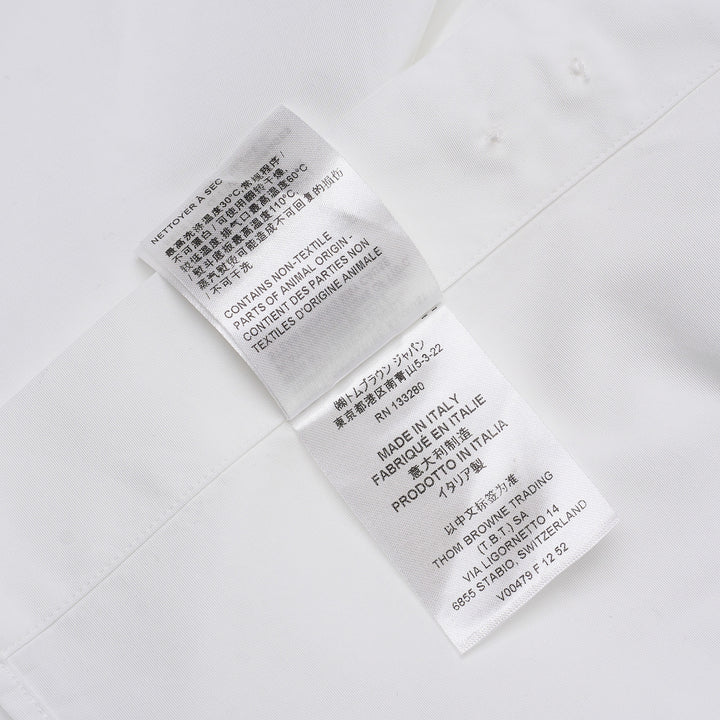 Thom Browne white long sleeve point collar shirt with signature red, white, and blue four-bar stripe on the sleeve, button-front placket, and chest pocket