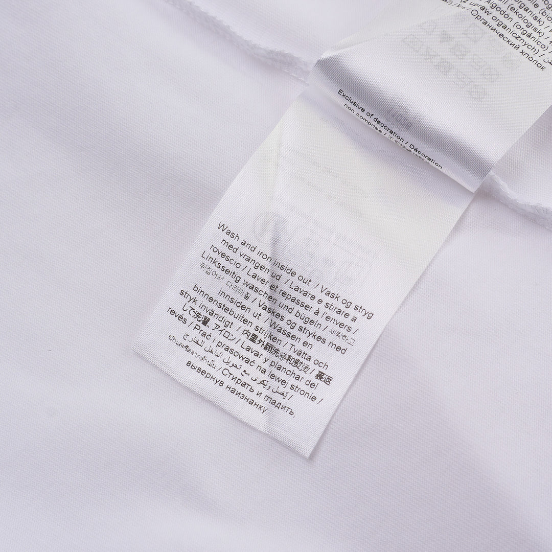 Ganni white cotton jersey tee featuring a large strawberry and daisy graphic print on the back with 'Have a nice day! Please recycle' slogan and Ganni logo in blue