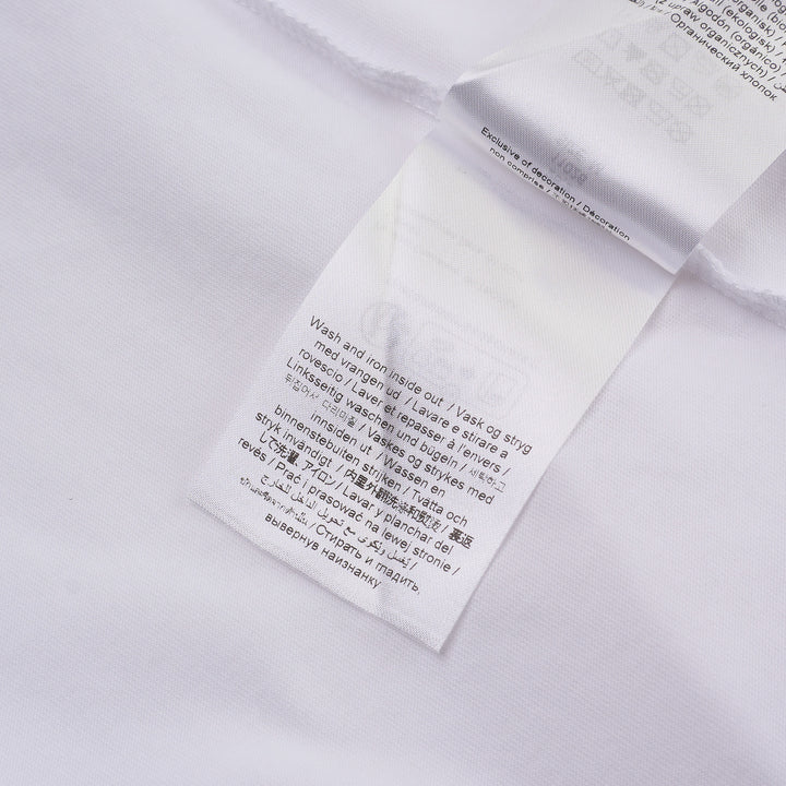 Ganni white cotton jersey tee featuring a large strawberry and daisy graphic print on the back with 'Have a nice day! Please recycle' slogan and Ganni logo in blue
