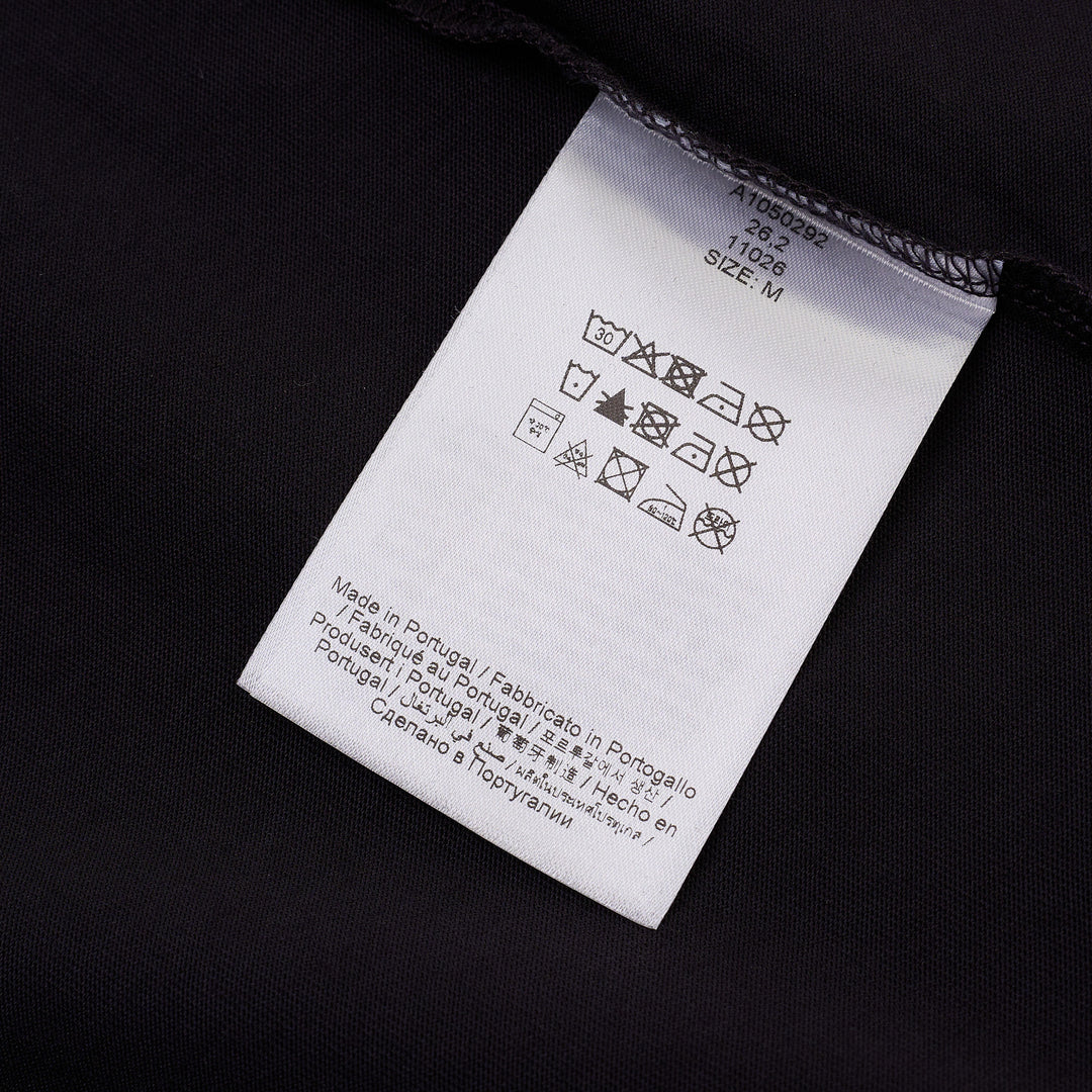 Ganni navy cotton jersey t-shirt with oversized strawberry and daisy graphic print, blue grunge-style Ganni logo, and 'Have a nice day! Please recycle' slogan on the front