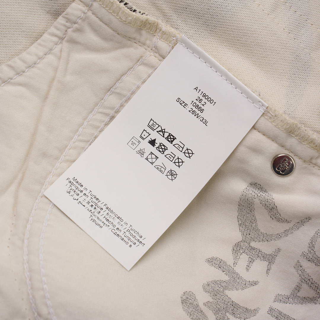 Ganni wide leg jeans in cream denim with an all-over charcoal and brown tiger stripe animal print, featuring a high-rise waist and dramatically flared leg