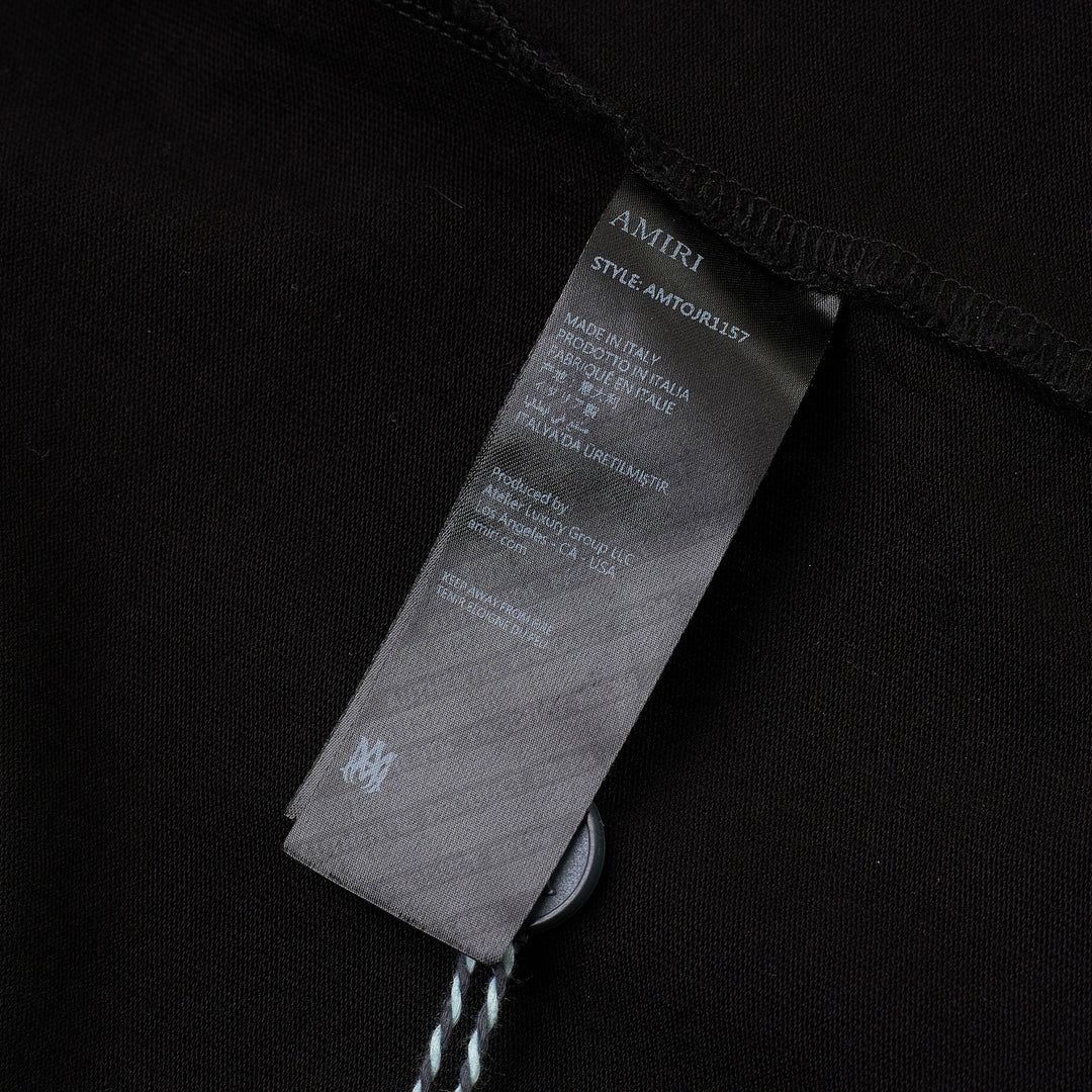 Amiri Arts District Skate Tee in black with tonal embossed chest branding, oversized silhouette and ribbed crewneck, front view