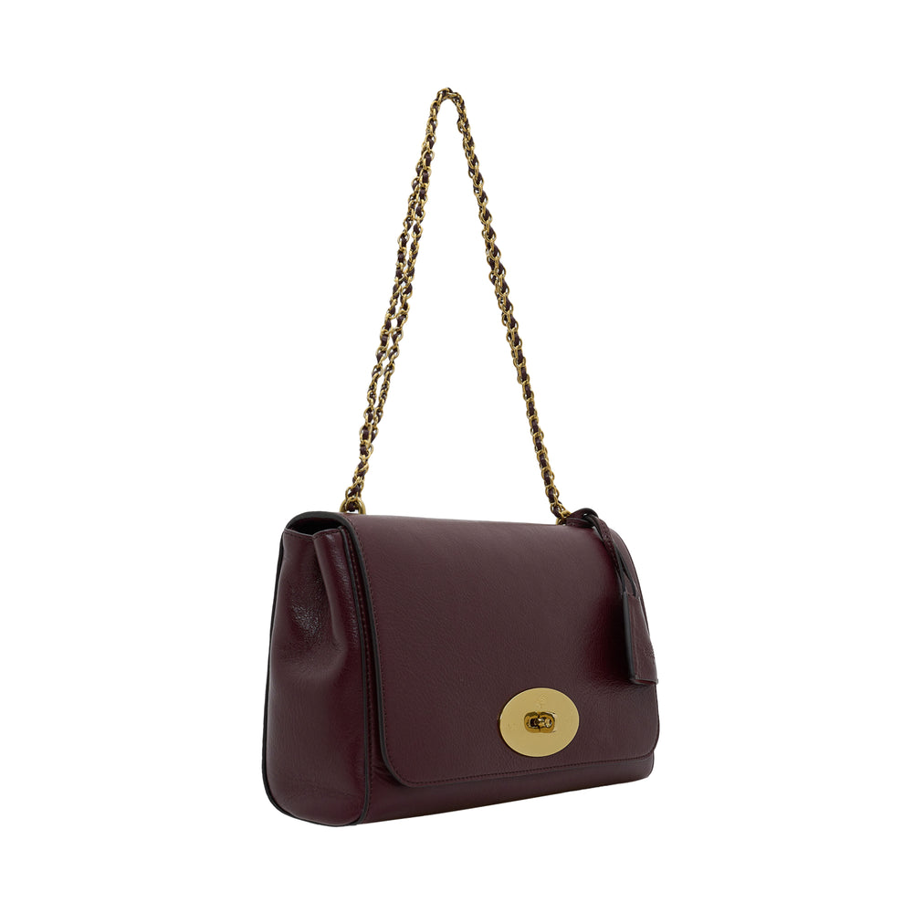 Mulberry Medium Lily High Shine bag in deep oxblood grained leather with woven gold chain strap and antique gold postman's lock closure, shot against a white background