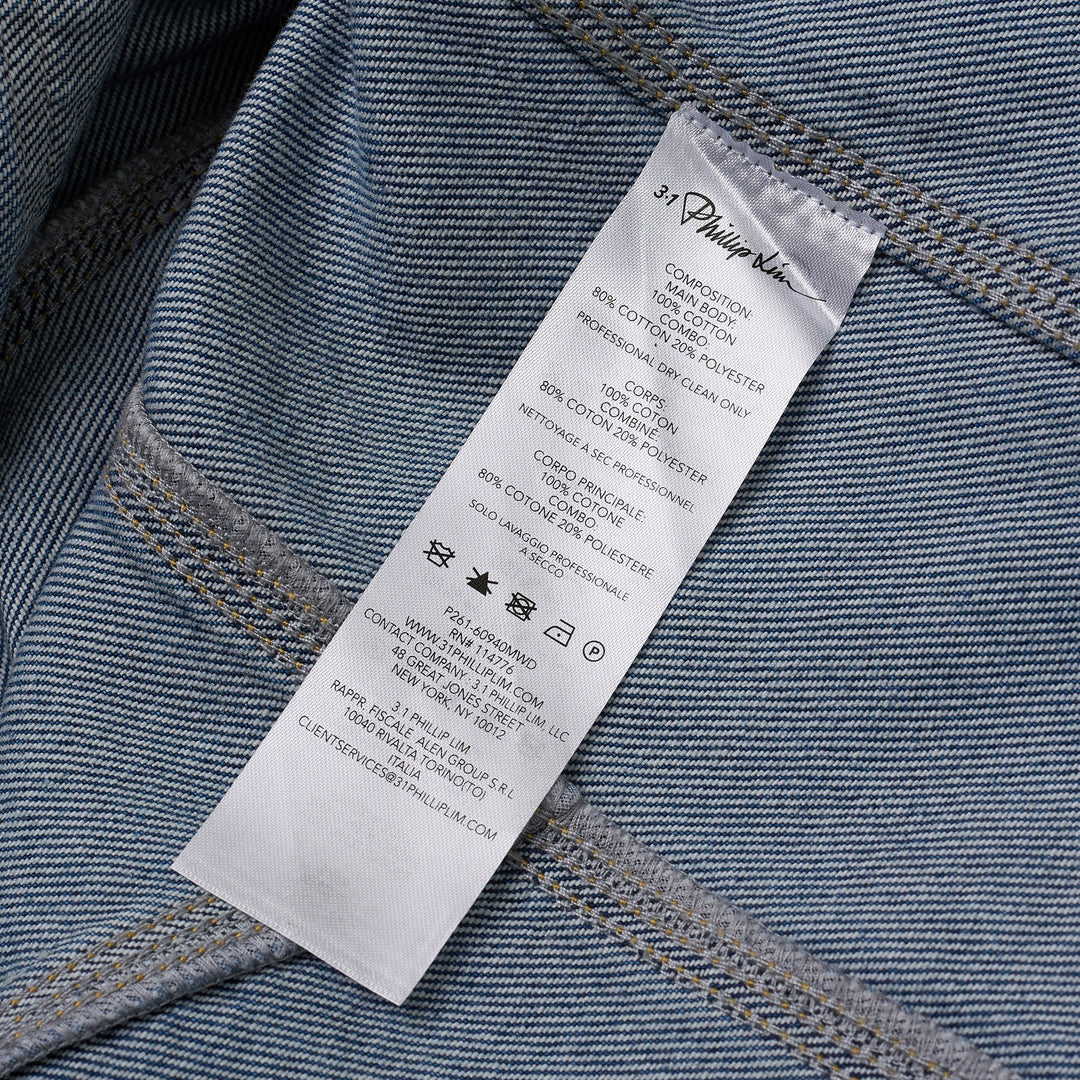 3.1 Phillip Lim mid-wash blue denim chore jacket with brown corduroy collar and chest pocket trims, silver snap-button front closure, and four patch pockets, displayed flat on white background