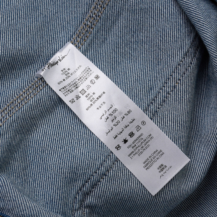 3.1 Phillip Lim mid-wash blue denim chore jacket with brown corduroy collar and chest pocket trims, silver snap-button front closure, and four patch pockets, displayed flat on white background