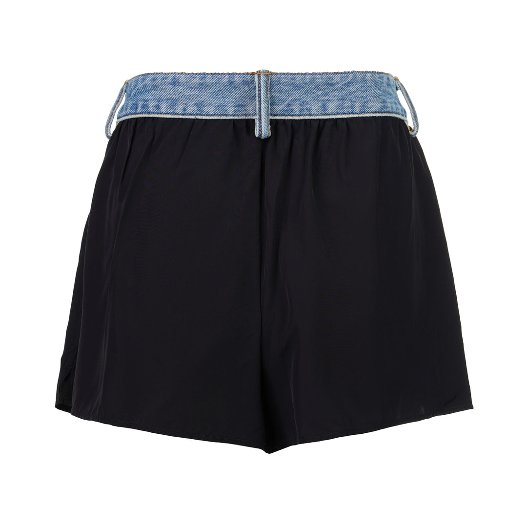 Alexander Wang mid-rise shorts with acid-wash denim waistband and pleated black fabric body, featuring silver snap button and contrast orange topstitching