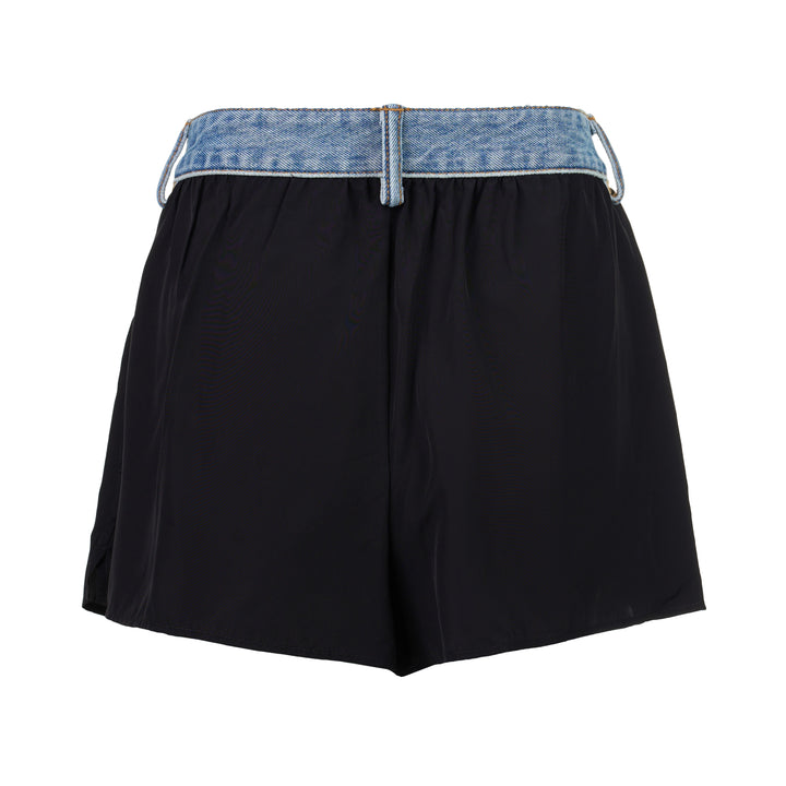 Alexander Wang mid-rise shorts with acid-wash denim waistband and pleated black fabric body, featuring silver snap button and contrast orange topstitching