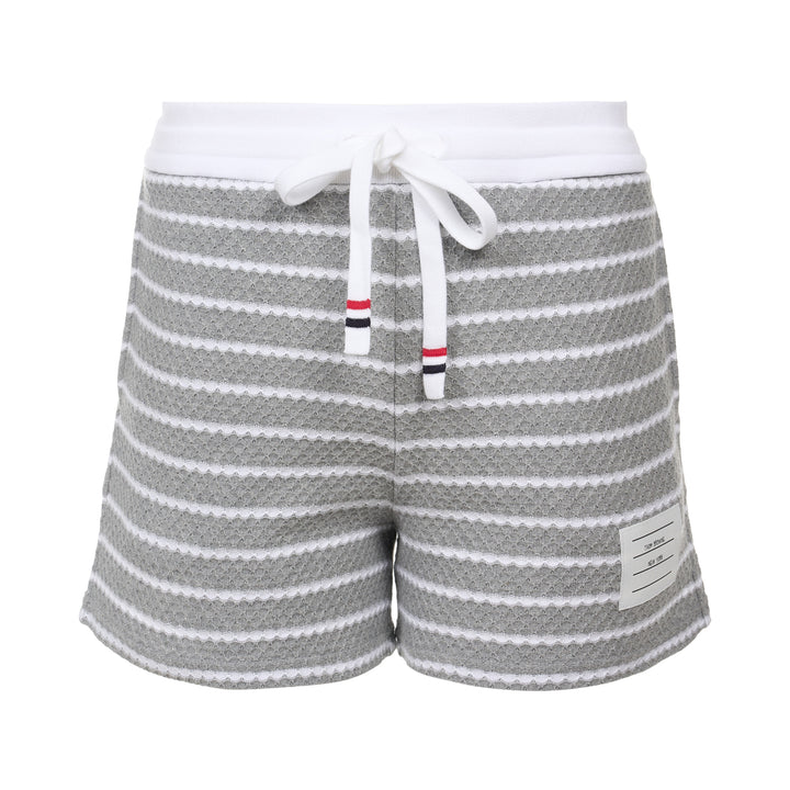 Thom Browne grey and white striped honeycomb-textured knit shorts with white ribbed waistband, drawstring tie with stripe detail, and woven brand label at hem