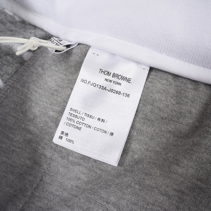 Thom Browne grey and white striped honeycomb-textured knit shorts with white ribbed waistband, drawstring tie with stripe detail, and woven brand label at hem - view 3