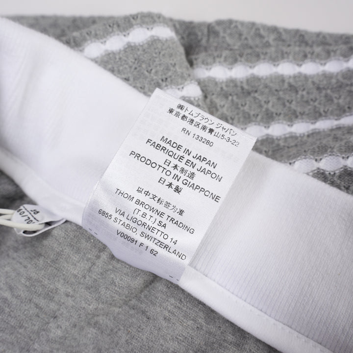 Thom Browne grey and white striped honeycomb-textured knit shorts with white ribbed waistband, drawstring tie with stripe detail, and woven brand label at hem - view 5