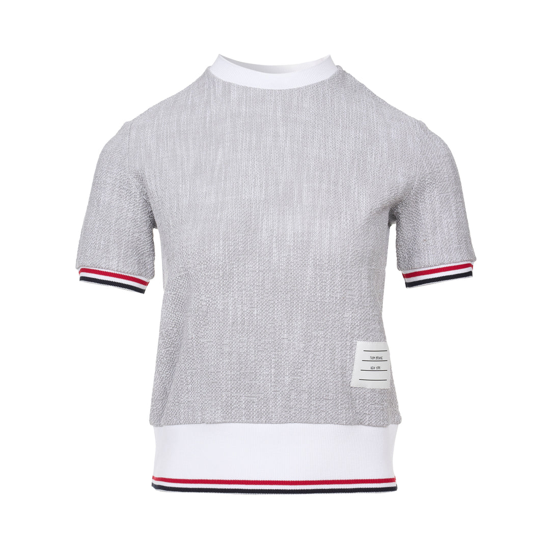 Thom Browne heather grey textural knit short sleeve tee with red, white, and blue striped tipping on sleeve cuffs and hem, white ribbed crew neck and hem band, and woven brand label on chest