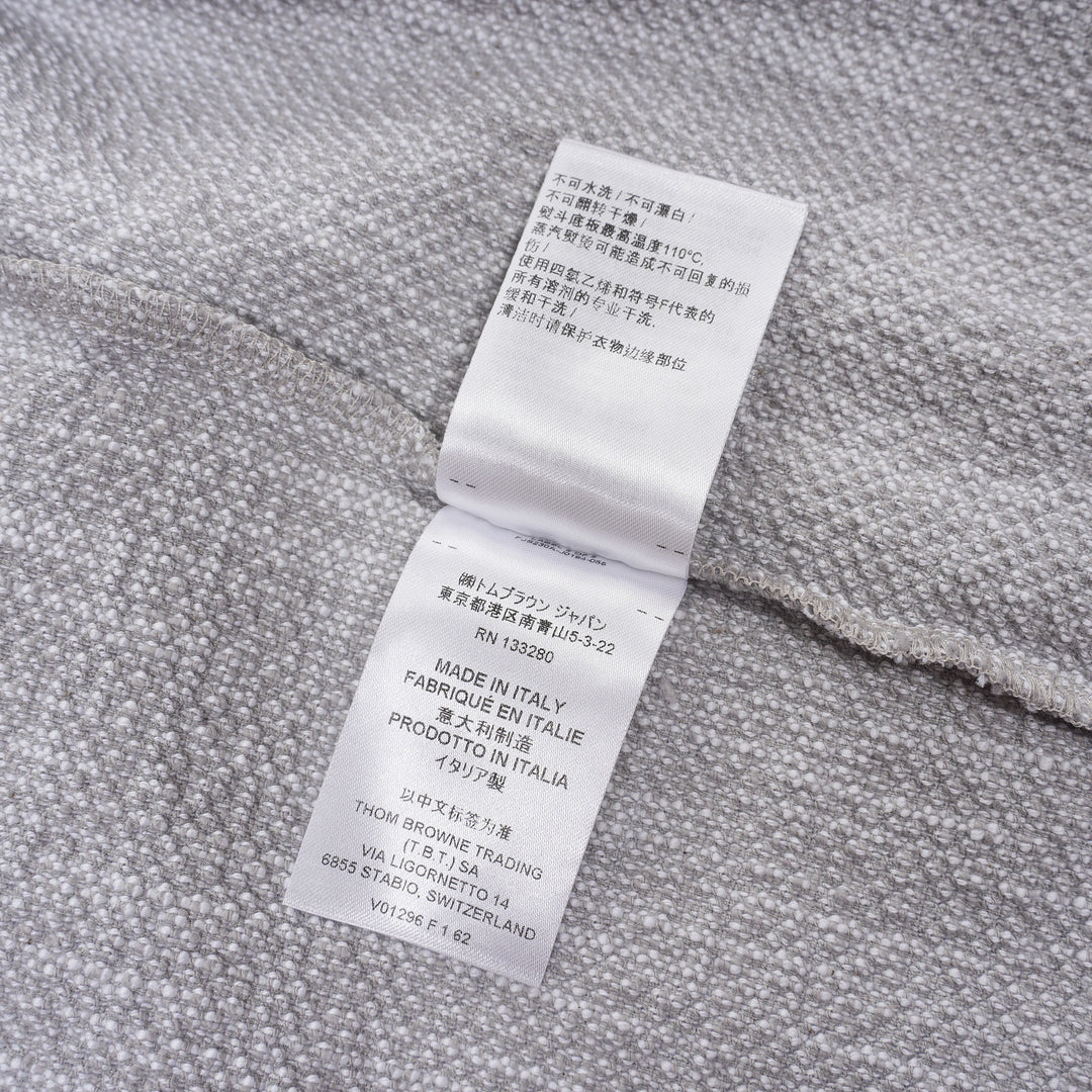 Thom Browne heather grey textural knit short sleeve tee with red, white, and blue striped tipping on sleeve cuffs and hem, white ribbed crew neck and hem band, and woven brand label on chest - view 5