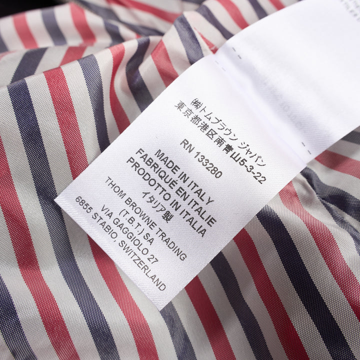 Thom Browne grey pleated mini skirt with tonal 4-bar stripe on one panel and red, white, and blue grosgrain tab at hem - view 5