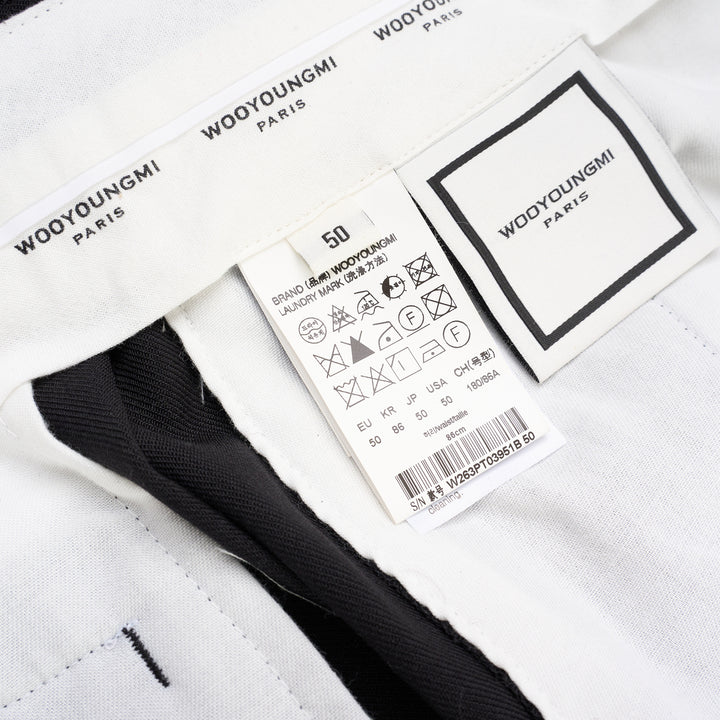Wooyoungmi black pleated high-rise trousers with double front pleats and side metal buckle adjuster, displayed flat on white background - view 3