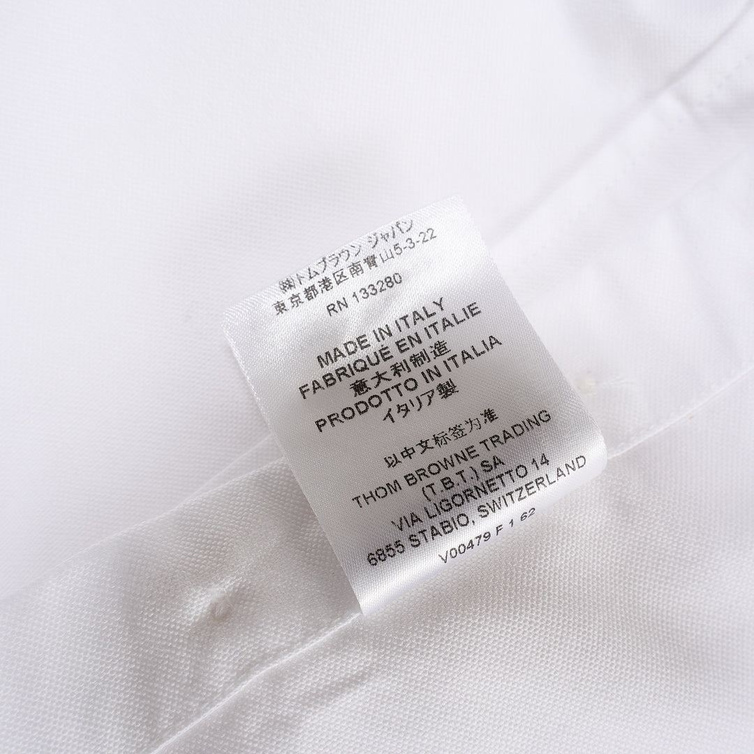 Thom Browne white oxford long sleeve shirt with rounded collar, button-front placket, single chest pocket, and signature four-bar grey stripe across one sleeve - view 6