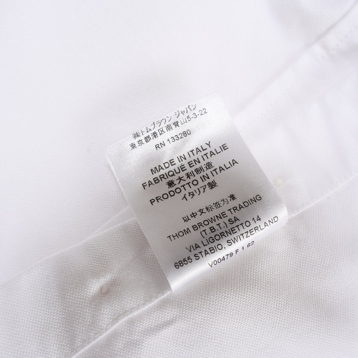 Thom Browne white oxford long sleeve shirt with rounded collar, button-front placket, single chest pocket, and signature four-bar grey stripe across one sleeve - view 6