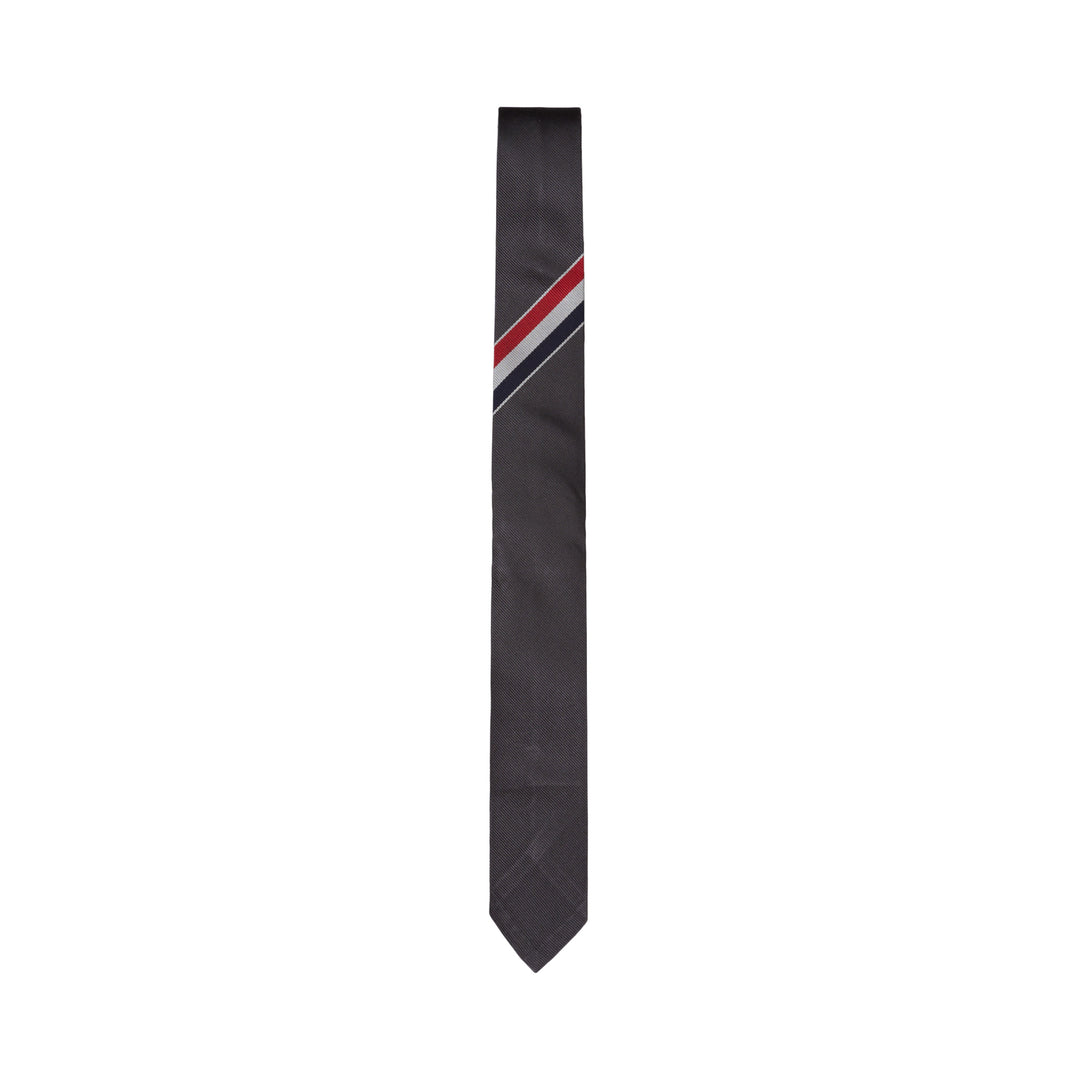 Thom Browne charcoal grey silk tie with diagonal red, white, and blue stripe