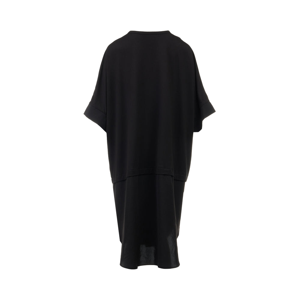 Y's black oversized round neck shirt dress with short folded cuffs, layered T-shirt upper, and buttoned skirt panel, displayed on white background - view 2