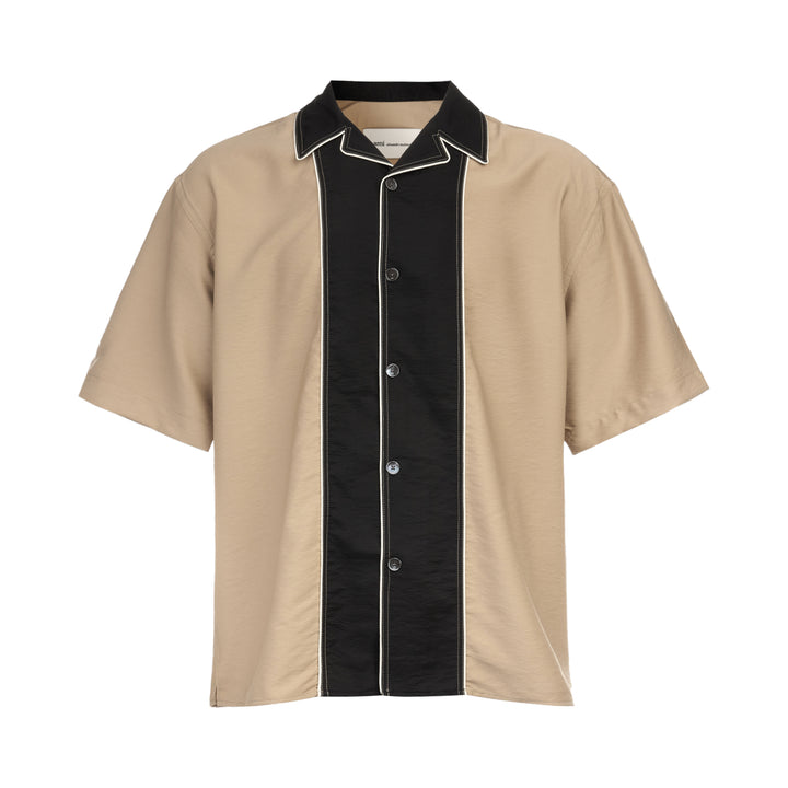 AMI Alexandre Mattiussi Shark Collar Boxy Short Sleeve Shirt in tan and black with contrast cream piping and button-through front, flat lay on white background
