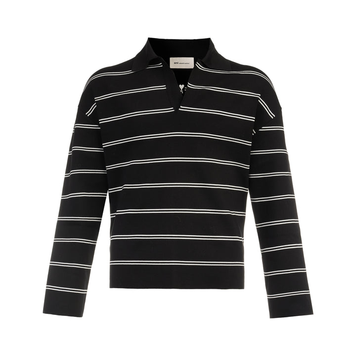 AMI Alexandre Mattiussi Long Sleeve Striped Polo in black with white horizontal stripes, featuring a spread collar, half-zip placket with heart logo pull, and ribbed cuffs