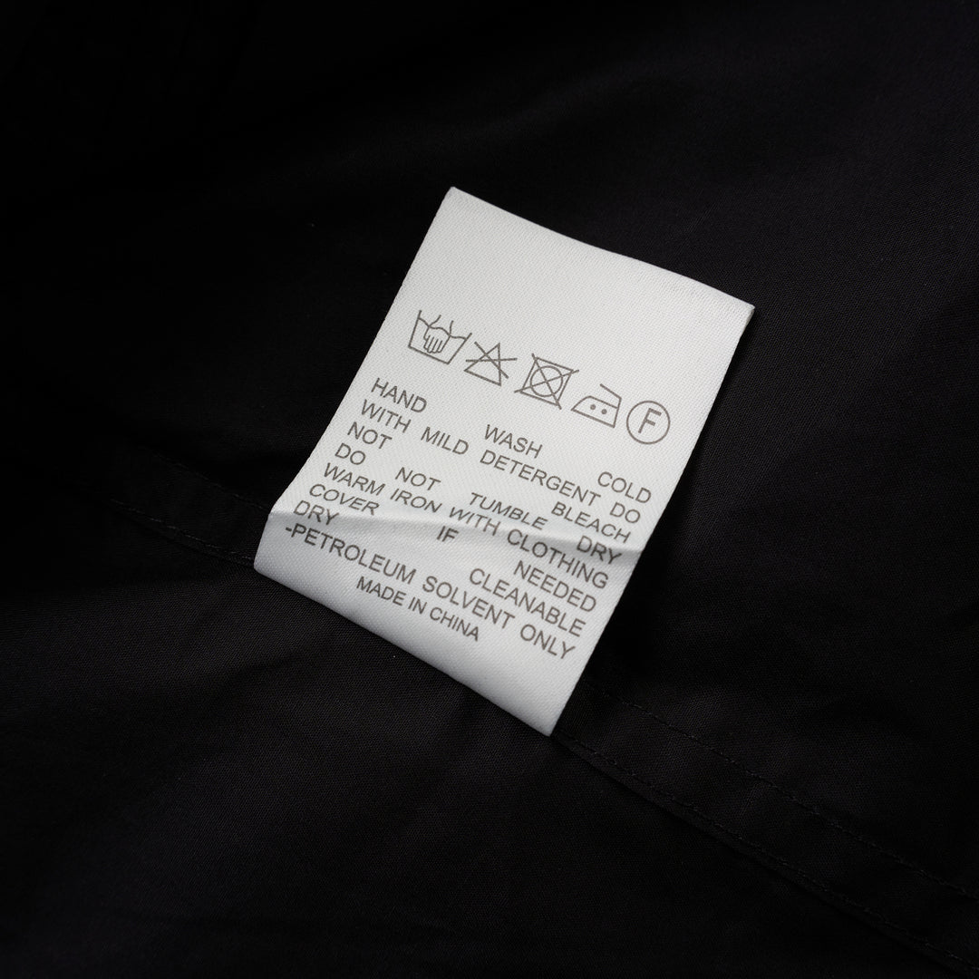 Black sleeveless cotton shirt with pintucked bib front, mandarin collar and self-fabric waist tie - view 4