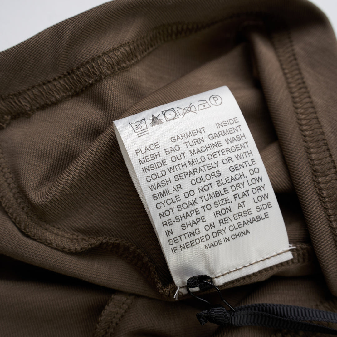Taupe brown mock-neck short sleeve jersey tee with gathered draping at the side seam and an asymmetric hem - view 4