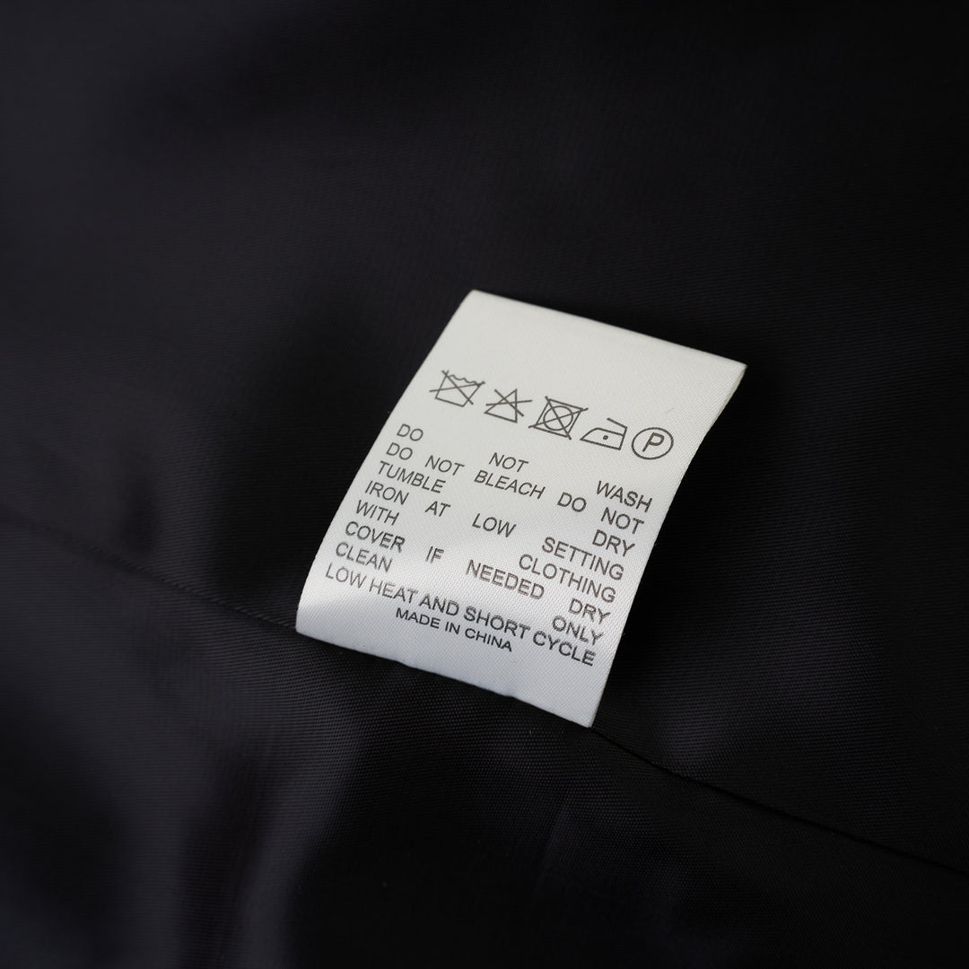 Black collarless wool-blend blazer with deep V neckline, single button closure and welt chest pocket, shown against a white background - view 4