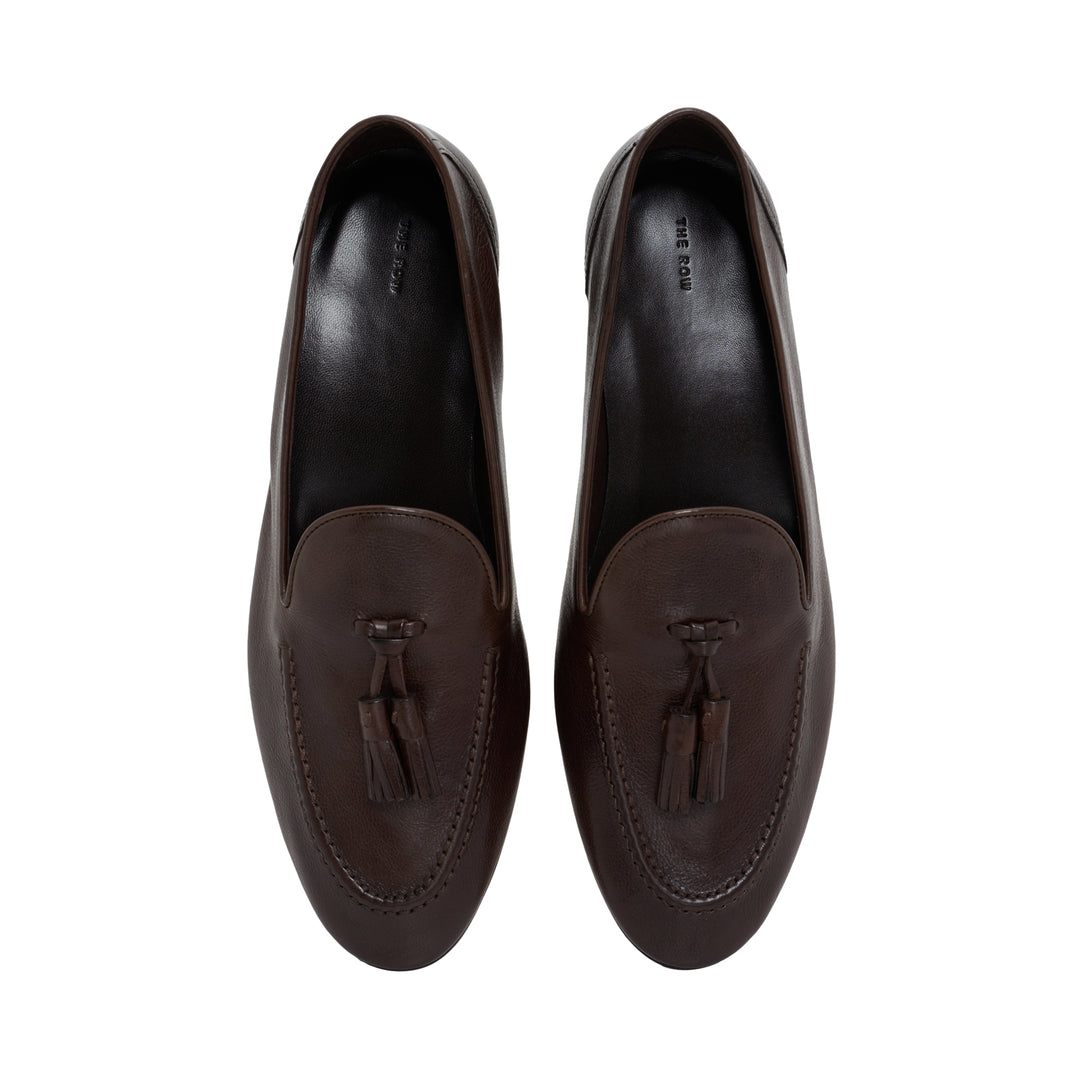 The Row Caden loafer in brown grained leather with leather tassel, moccasin stitching and low stacked heel, side view - view 4