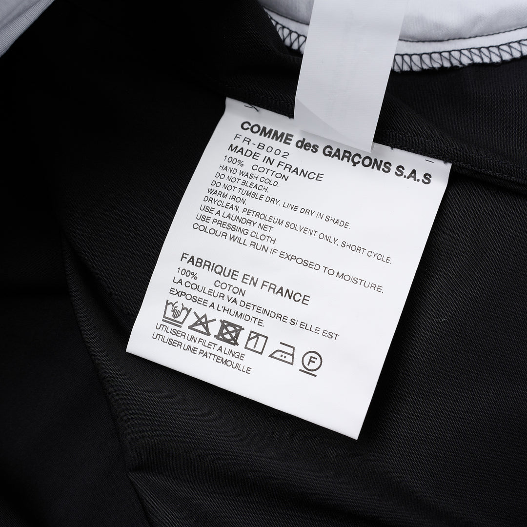 Comme des Garçons Shirt black long sleeve button-up shirt with curved white patchwork panels on the front - view 3