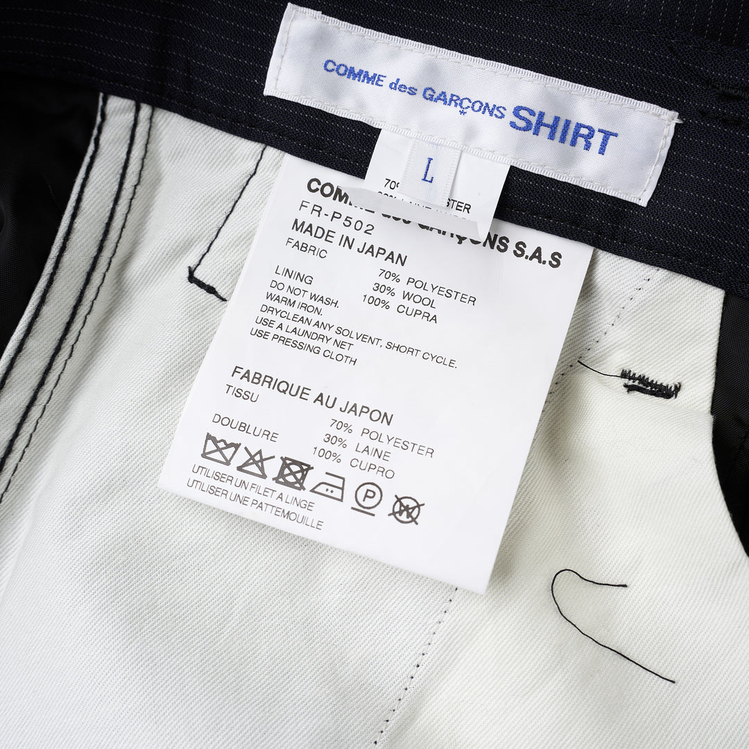 Navy pinstripe pleated cargo shorts by Comme des Garçons Shirt with a wide-leg cut, flap pockets and button fly, shown from the front - view 3