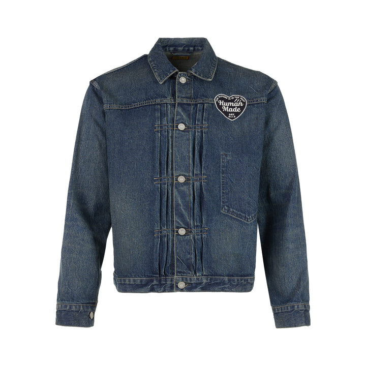 Human Made washed indigo denim work jacket with pleated front, button closure and heart-shaped logo patch on the chest